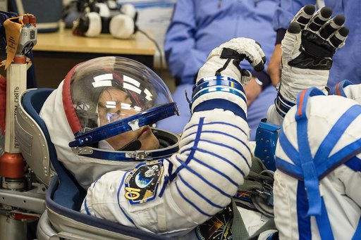 In the Integration Facility at the Baikonur Cosmodrome in Kazakhstan, Expedition 48-49 crewmember Takuya Onishi of the Japan Aerospace Exploration Agency conducts a leak check of his Russian Sokol launch and entry suit June 25 as part of the preparations for launch with Anatoly Ivanishin of Roscosmo