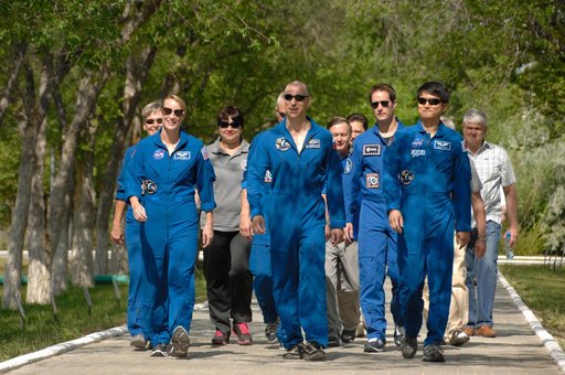 At the Cosmonaut Hotel in Baikonur, Kazakhstan, Expedition 48-49 crewmembers Kate Rubins of NASA (left), Anatoly Ivanishin of Roscosmos (center) and Takuya Onishi of the Japan Aerospace Exploration Agency (right) take a stroll down the �ޔWalk of Cosmonauts��� June 30 as part of their pre-launch acti