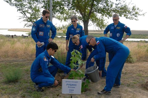 At the Cosmonaut Hotel in Baikonur, Kazakhstan, Expedition 48-49 crewmember Kate Rubins of NASA (front row, center) helps to plant a tree in her name in traditional pre-launch activities June 30 with the assistance of prime crewmates Takuya Onishi of the Japan Aerospace Exploration Agency (front row