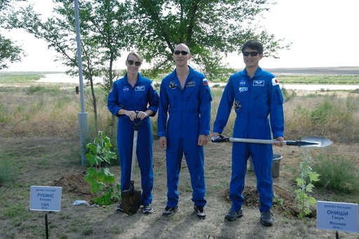 At the Cosmonaut Hotel in Baikonur, Kazakhstan, Expedition 48-49 crewmembers Kate Rubins of NASA (left), Anatoly Ivanishin of Roscosmos (center) and Takuya Onishi of the Japan Aerospace Exploration Agency (right) pose for pictures June 30 after Rubins and Onishi, both first-time fliers, planted tree