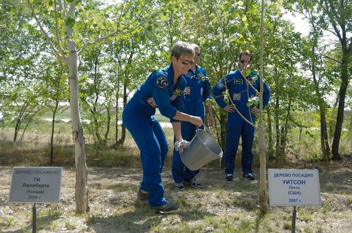 At the Cosmonaut Hotel in Baikonur, Kazakhstan, Expedition 48-49 backup crewmember Peggy Whitson of NASA waters a tree in her name first planted in 2007 during traditional pre-launch activities June 30. Whitson is one of three backups to the prime crewmembers, Kate Rubins of NASA, Anatoly Ivanishin 