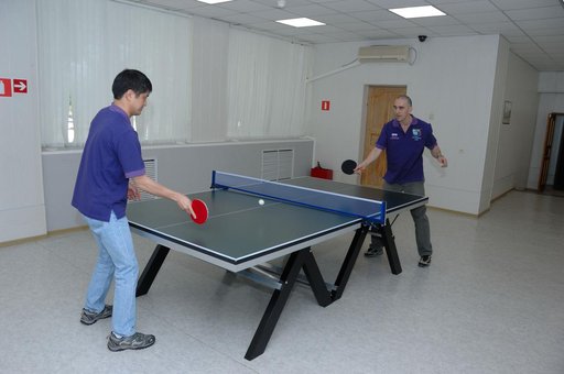 At the Cosmonaut Hotel in Baikonur, Kazakhstan, Expedition 48-49 crewmembers Takuya Onishi of the Japan Aerospace Exploration Agency (left) and Anatoly Ivanishin of Roscosmos share a game of ping-pong June 30 during pre-launch activities. They and Kate Rubins of NASA will launch July 7, Baikonur tim