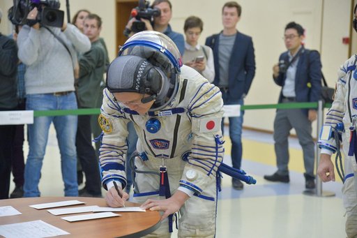 jsc2017e135202 - At the Gagarin Cosmonaut Training Center in Star City, Russia, Expedition 54-55 prime crewmember Norishige Kanai of the Japan Aerospace Exploration Agency (JAXA) signs in for the start of the crew’s final qualification exam activities N