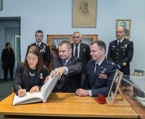 jsc2019e004426 - At the Gagarin Museum in the Gagarin Cosmonaut Training Center in Star City, Russia, Expedition 59 crewmember Christina Koch of NASA (front, left) signs a ceremonial book Feb. 21 as part of the crewâ€™s pre-launch activities as her crewma
