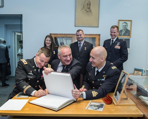 jsc2019e004427 - At the Gagarin Museum in the Gagarin Cosmonaut Training Center in Star City, Russia, Expedition 59 backup crewmember Drew Morgan of NASA (front, left) signs a ceremonial book Feb. 21 as his crewmates, Alexander Skvortsov of Roscosmos (cen