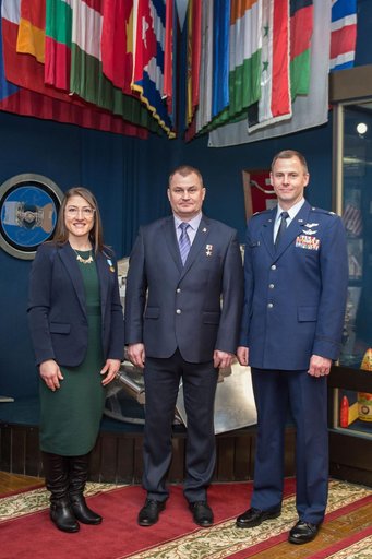 jsc2019e004428 - At the Gagarin Museum in the Gagarin Cosmonaut Training Center in Star City, Russia, Expedition 59 crewmembers Christina Koch of NASA (left), Alexey Ovchinin of Roscosmos (center) and Nick Hague of NASA (right) pose for pictures Feb. 21 f