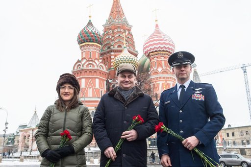 jsc2019e004431 - With St. Basilâ€™s Cathedral in Red Square in Moscow providing a wintry backdrop, Expedition 59 crewmembers Christina Koch of NASA (left), Alexey Ovchinin of Roscosmos (center) and Nick Hague of NASA (right) pose for pictures Feb. 21 prio