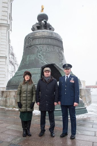 jsc2019e004438 - Inside the Kremlin in Moscow, Expedition 59 crewmembers Christina Koch of NASA (left), Alexey Ovchinin of Roscosmos (center) and Nick Hague of NASA (right) pose for pictures in front of the Tsar Bell on a wintry day Feb. 21 as part of the