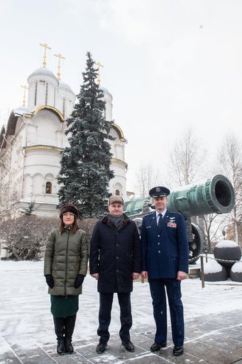 jsc2019e004439 - Inside the Kremlin in Moscow, Expedition 59 crewmembers Christina Koch of NASA (left), Alexey Ovchinin of Roscosmos (center) and Nick Hague of NASA (right) pose for pictures in front of the Tsar Cannon on a wintry day Feb. 21 as part of t