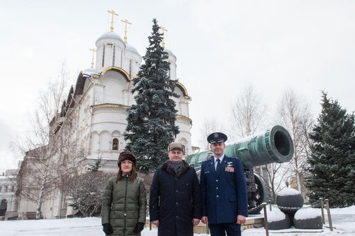 jsc2019e004440 - Inside the Kremlin in Moscow, Expedition 59 crewmembers Christina Koch of NASA (left), Alexey Ovchinin of Roscosmos (center) and Nick Hague of NASA (right) pose for pictures in front of the Tsar Cannon on a wintry day Feb. 21 as part of t