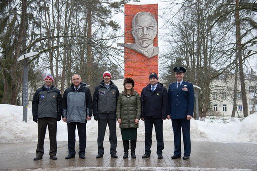 At the Gagarin Cosmonaut Training Center in Star City, Russia, the Expedition 59 prime and backup crewmembers pose for pictures Feb. 26 in front of the statue of Vladimir Lenin as they prepared to depart for their launch site at the Baikonur Cosmodrome in