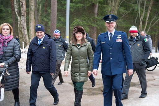 At the Gagarin Cosmonaut Training Center in Star City, Russia, Expedition 59 crewmembers Alexey Ovchinin of Roscosmos (second from left), Christina Koch of NASA (second from right) and Nick Hague of NASA (right) walk to a bus Feb. 26 to take them to their