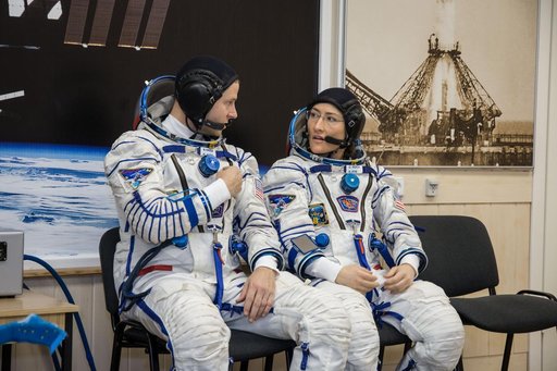 jsc2019e009948 - At the Baikonur Cosmodrome in Kazakhstan, Expedition 59 crewmembers Nick Hague (left) and Christina Koch (right) of NASA discuss procedures Feb. 27 during a Soyuz fit check dress rehearsal that is part of pre-launch training. Hague, Koch