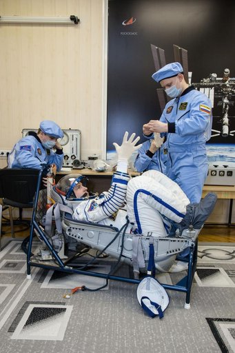 jsc2019e009949 = At the Baikonur Cosmodrome in Kazakhstan, Expedition 59 crewmember Nick Hague of NASA undergoes a Sokol launch suit pressure check Feb. 27 during pre-launch training. Hague, Christina Koch of NASA and Alexey Ovchinin of Roscosmos will lau