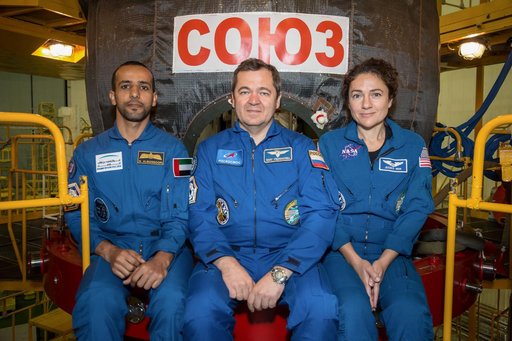 jsc2019e052880 - In the Integration Building at the Baikonur Cosmodrome in Kazakhstan, spaceflight participant Hazzaa Ali Almansoori of the United Arab Emirates (left) and Expedition 61 crewmates Oleg Skripochka of Roscosmos (center) and Jessica Meir of N