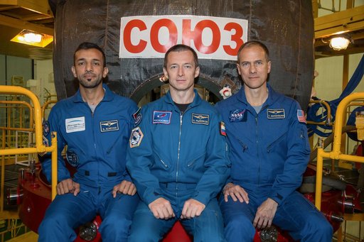 jsc2019e052883 - In the Integration Building at the Baikonur Cosmodrome in Kazakhstan, backup spaceflight participant Sultan Al-Neyadi of the United Arab Emirates (left) and backup Expedition 61 crewmates Sergey Ryzhikov of Roscosmos (center) and Tom Mars