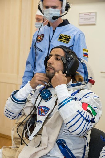 jsc2019e052884 - In the Integration Building at the Baikonur Cosmodrome in Kazakhstan, spaceflight participant Hazzaa Ali Almansoori of the United Arab Emirates suits up Sept. 11 for a fit check aboard the Soyuz MS-15 spacecraft. Almansoori, Oleg Skripoch