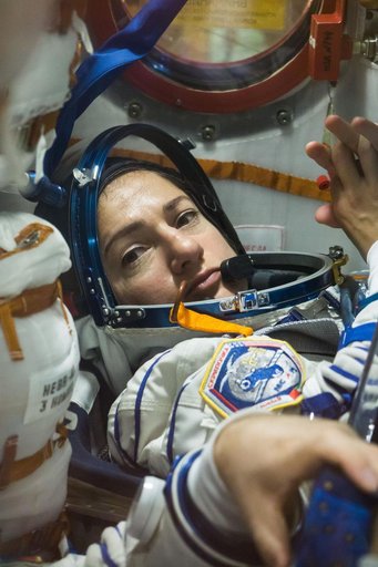 jsc2019e052895 - In the Integration Building at the Baikonur Cosmodrome in Kazakhstan, Expedition 61 crewmember Jessica Meir of NASA runs through procedures Sept. 11 aboard the Soyuz MS-15 spacecraft during an initial Soyuz vehicle fit check. Meir, spacef