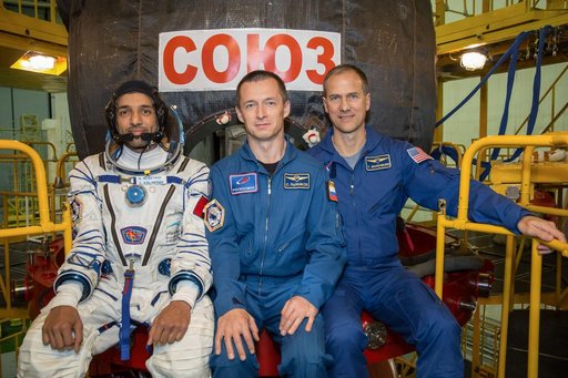 jsc2019e052896 - In the Integration Building at the Baikonur Cosmodrome in Kazakhstan, backup spaceflight participant Sultan Al-Neyadi of the United Arab Emirates (left) and backup Expedition 61 crewmates Sergey Ryzhikov of Roscosmos (center) and Tom Mars