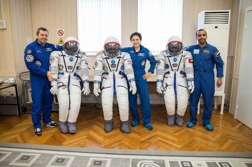jsc2019e052897 - In the Integration Building at the Baikonur Cosmodrome in Kazakhstan, Expedition 61 crewmembers Oleg Skripochka of Roscosmos (left) and Jessica Meir of NASA (center) and spaceflight participant Hazzaa Ali Almansoori of the United Arab Emi