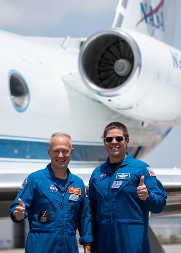 jsc2020e023070 - At Ellington Field near NASAâ€™s Johnson Space Center in Houston, astronauts Douglas Hurley(left) and Robert Behnken pose for a photo before boarding the Gulfstream jet that will carry them to the agencyâ€™s Kennedy Space Center in Florid