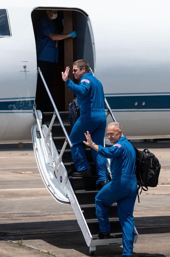 jsc2020e023071 - At Ellington Field near NASA’s Johnson Space Center in Houston, astronauts Robert Behnken(left) and Douglas Hurley board the Gulfstream jet that will carry them to the agency’s Kennedy Space Center in Florida on May 20, 2020, in prepa