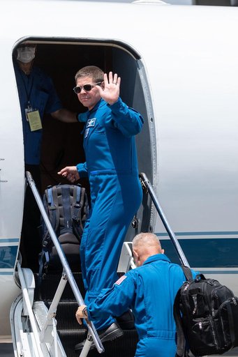 jsc2020e023072 - At Ellington Field near NASA’s Johnson Space Center in Houston, astronauts Robert Behnken(facing) and Douglas Hurley board the Gulfstream jet that will carry them to the agency’s Kennedy Space Center in Florida on May 20, 2020, in pre