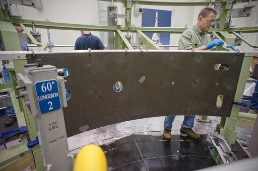 Installing the first composite panel on the EFT-1 Service Module