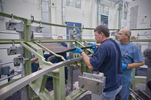 Installing the first composite panel on the EFT-1 Service Module