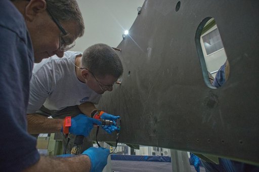 Drilling pilot holes in composite Service Module panel clamped t