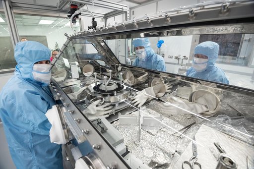 OSIRIS Rex curation team pouring the sample from the TAGSAM head