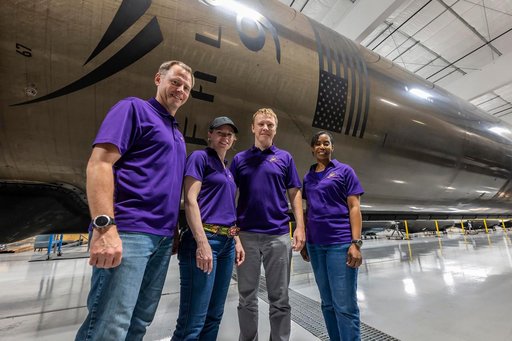 NASA’s SpaceX Crew-9 members stand in front of a Falcon 9 first-stage booster