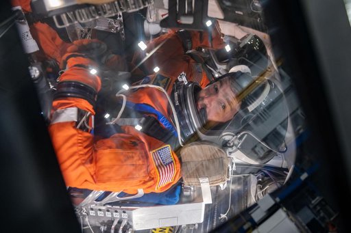 NASA astronauts and Artemis II crew members Reid Wiseman and Victor Glover inside of the Orion spacecraft mockup
