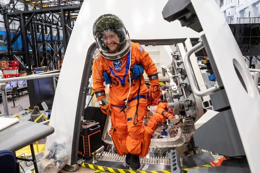 NASA astronaut and Artemis II mission specialist Christina Koch exits the Orion spacecraft mockup