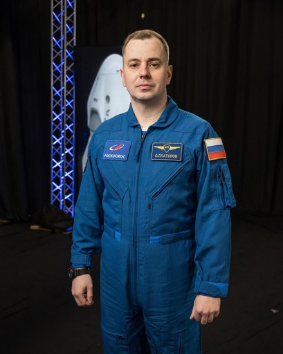 Roscosmos cosmonaut Oleg Platonov poses for a photo during an interview
