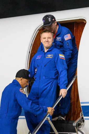 Roscosmos cosmonaut Aleksandr Gorbunov smiles as he returns to Johnson Space Center