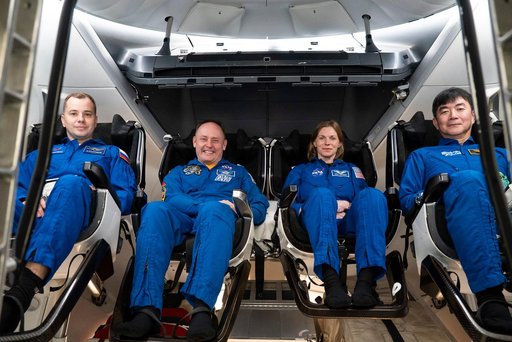NASA's SpaceX Crew-11 members pose for a portrait inside a Dragon training crew spacecraft