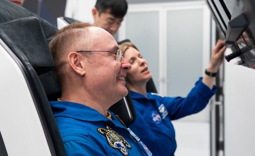 Astronaut Mike Fincke trains inside a Dragon training crew spacecraft