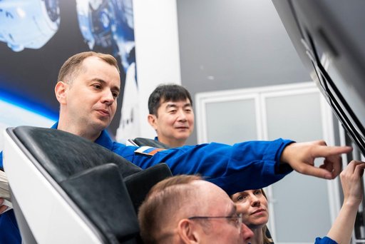 NASA's SpaceX Crew-11 members train inside a Dragon training crew spacecraft