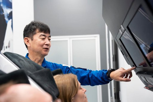Astronaut Kimiya Yui trains inside a Dragon training crew spacecraft