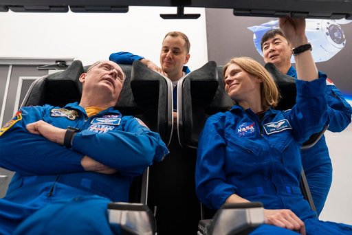 NASA's SpaceX Crew-11 members train inside a Dragon training crew spacecraft