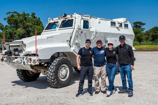 NASA's SpaceX Crew-11 members pose for a portrait by an emergency egress vehicle