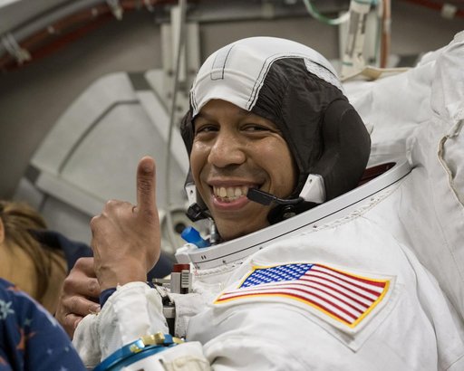 NASA astronaut Chris Williams poses for a photo in a spacesuit