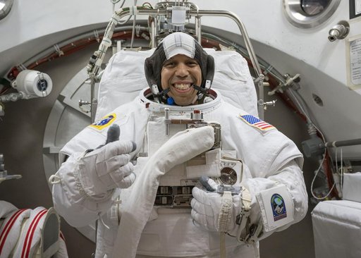 NASA astronaut Chris Williams poses for a photo in a spacesuit