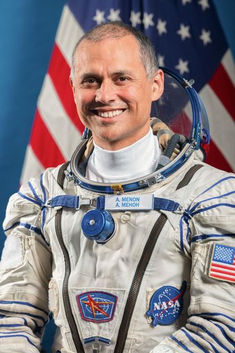 NASA astronaut Flight Engineer Anil Menon poses for a portrait in his Sokol launch and entry suit