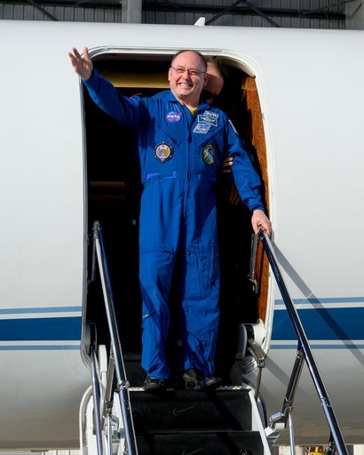 NASA astronaut Mike Fincke waves to officials at Ellington Field in Houston, Texas