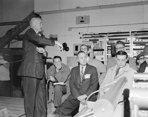 Astronaut John Glenn and news media representatives during tour of Cape
