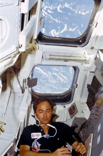 Pilot Crippen eats rehydrated food at aft flight deck onorbit station
