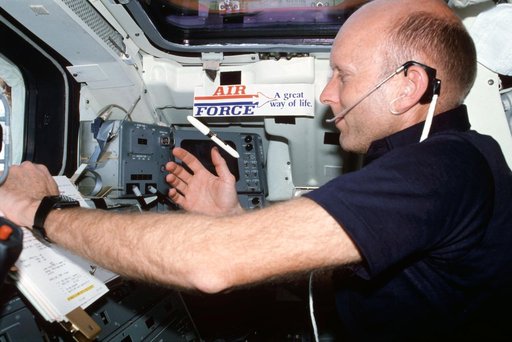 Pilot Fullerton reviews checklist on Aft Flight Deck Onorbit Station