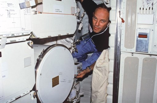 Commander Lousma adjusts MLR controls on middeck